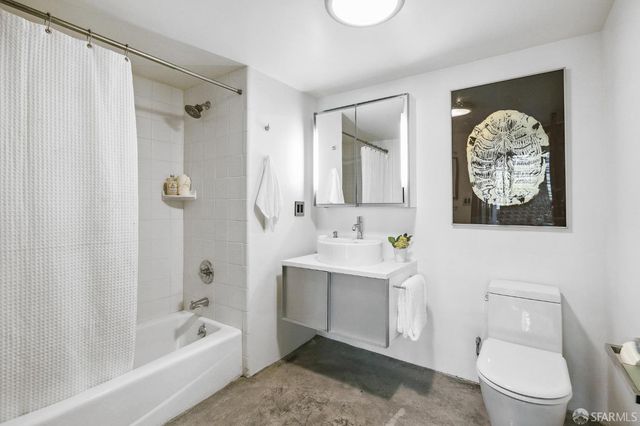 a living room filled with furniture and a floor to ceiling window