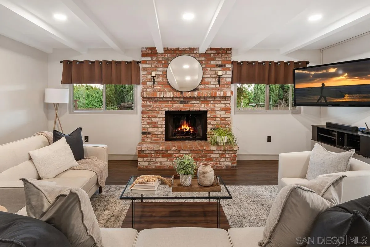 9469 Pike Road Santee, CA 92071 - Photo 11 of 39 a living room with furniture a fireplace and a flat screen tv