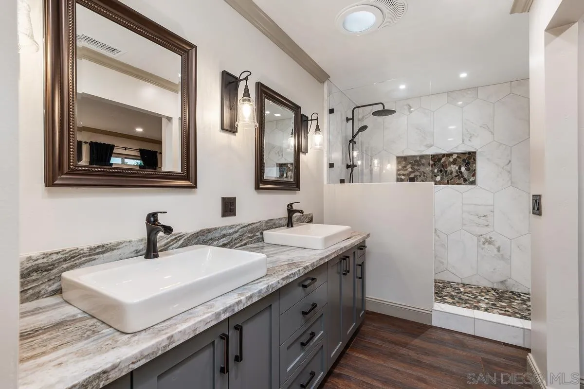 9469 Pike Road Santee, CA 92071 - Photo 16 of 39 a bathroom with double sink and two mirror