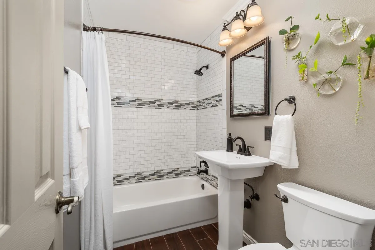 9469 Pike Road Santee, CA 92071 - Photo 17 of 39 a bathroom with a sink mirror toilet and shower
