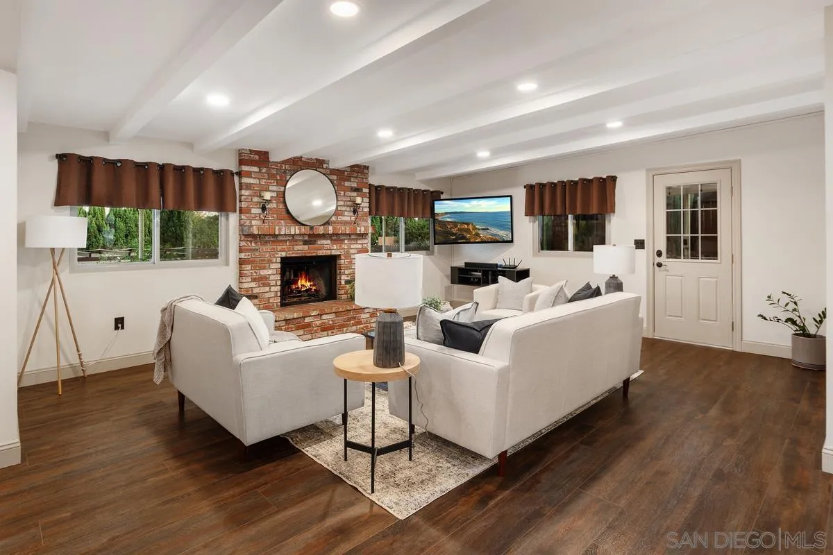 9469 Pike Road Santee, CA 92071 - Photo 10 of 39 a living room with furniture a fireplace and a flat screen tv