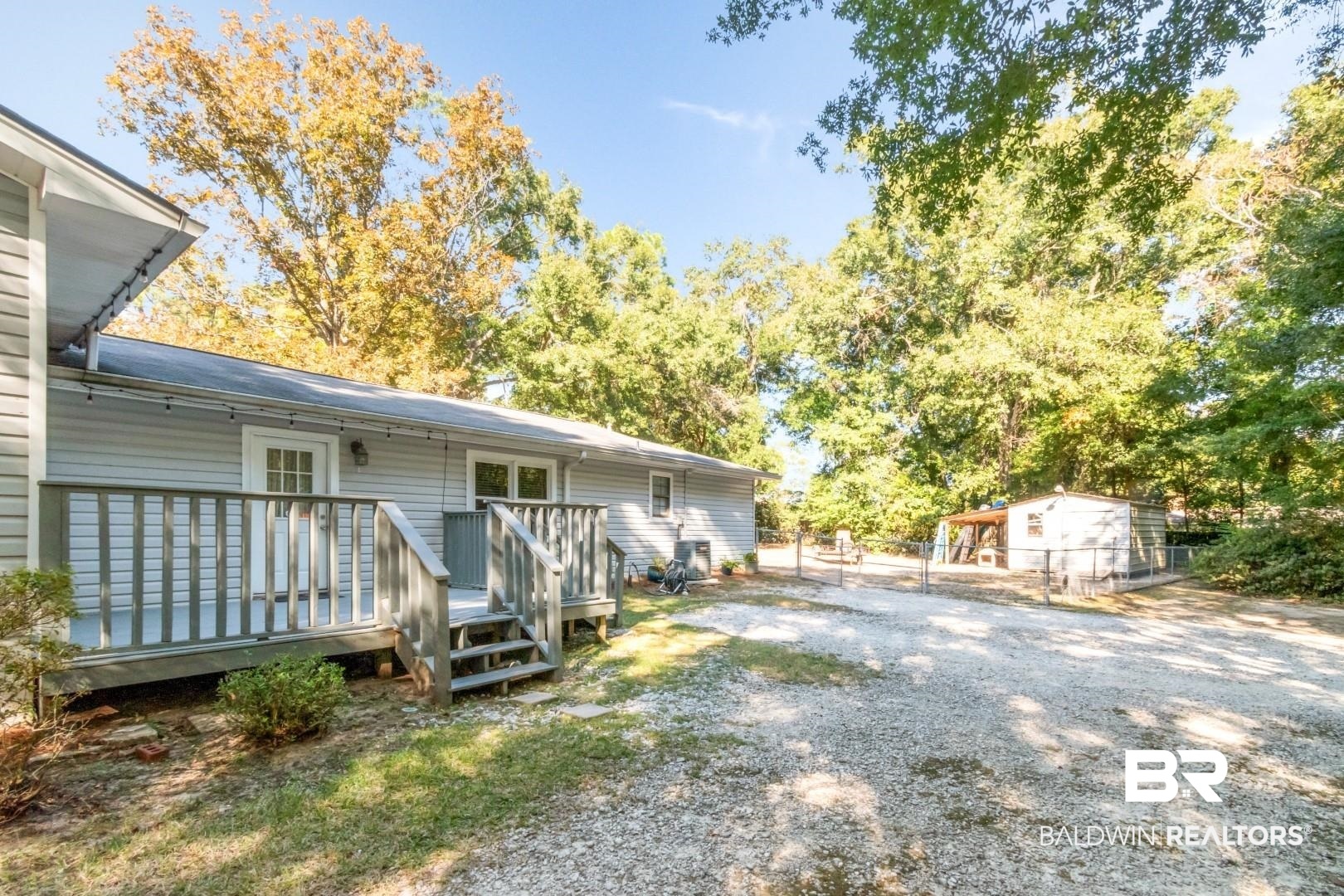 1321 Rainbow Drive West Mobile, AL 36693 - Photo 34 of 48 Exterior space featuring a deck and an outdoor structure