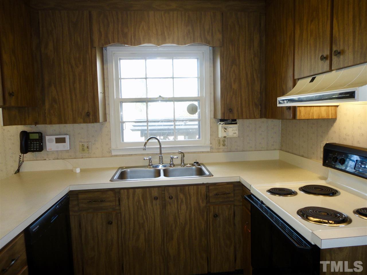 2907 New Hope Church Road Raleigh, NC 27604 - Photo 8 of 25 a kitchen with a sink a stove and cabinets
