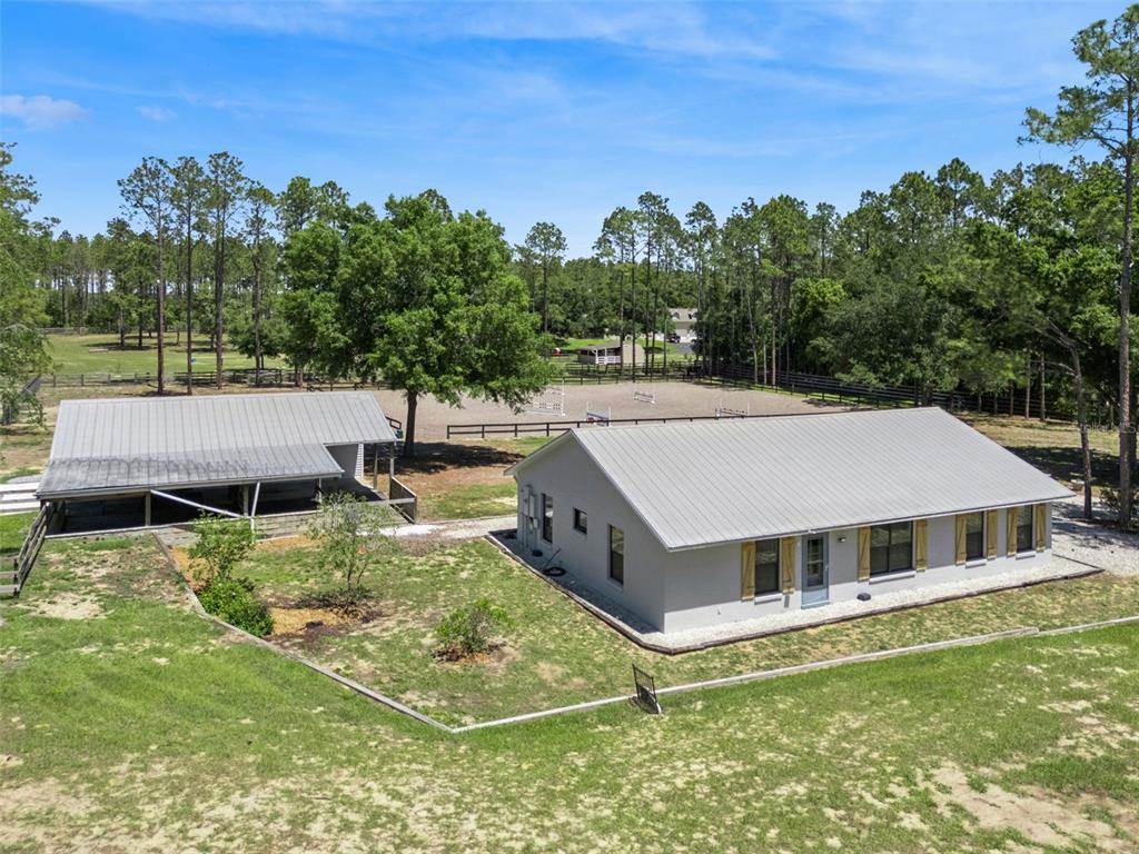 20701 County Road 44A Eustis, FL 32736 - Photo 2 of 73 a aerial view of a house with swimming pool next to a big yard