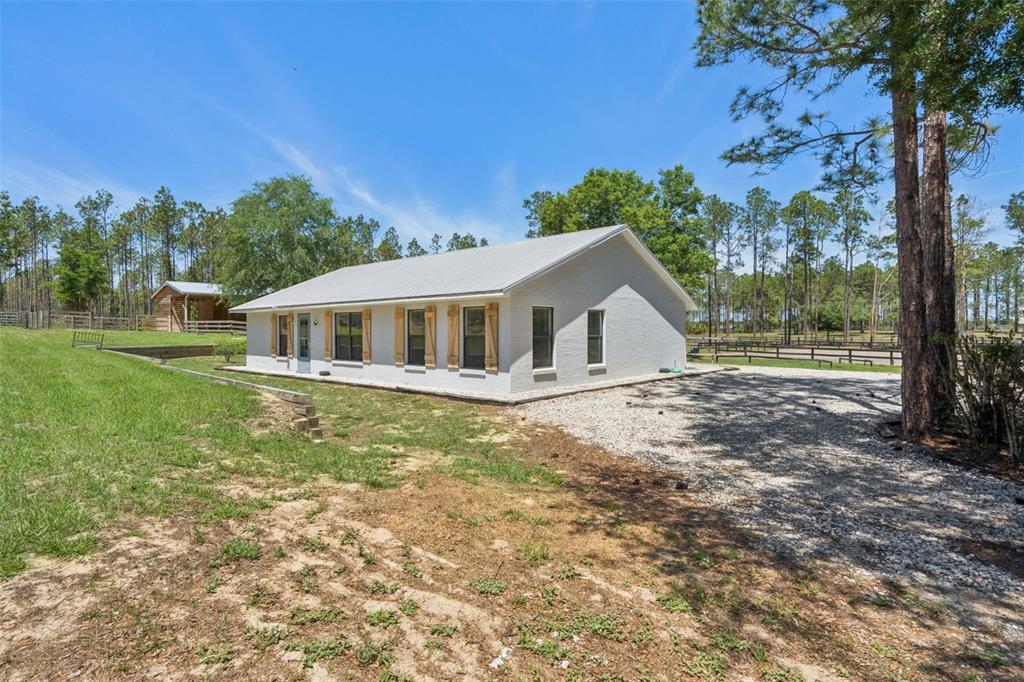 20701 County Road 44A Eustis, FL 32736 - Photo 43 of 73 a view of a house with backyard and trees