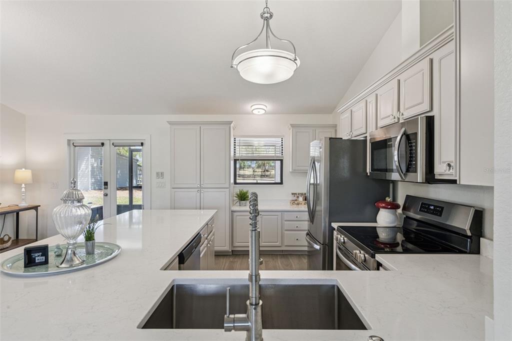 20701 County Road 44A Eustis, FL 32736 - Photo 55 of 73 a kitchen with stainless steel appliances kitchen island granite countertop a sink and cabinets