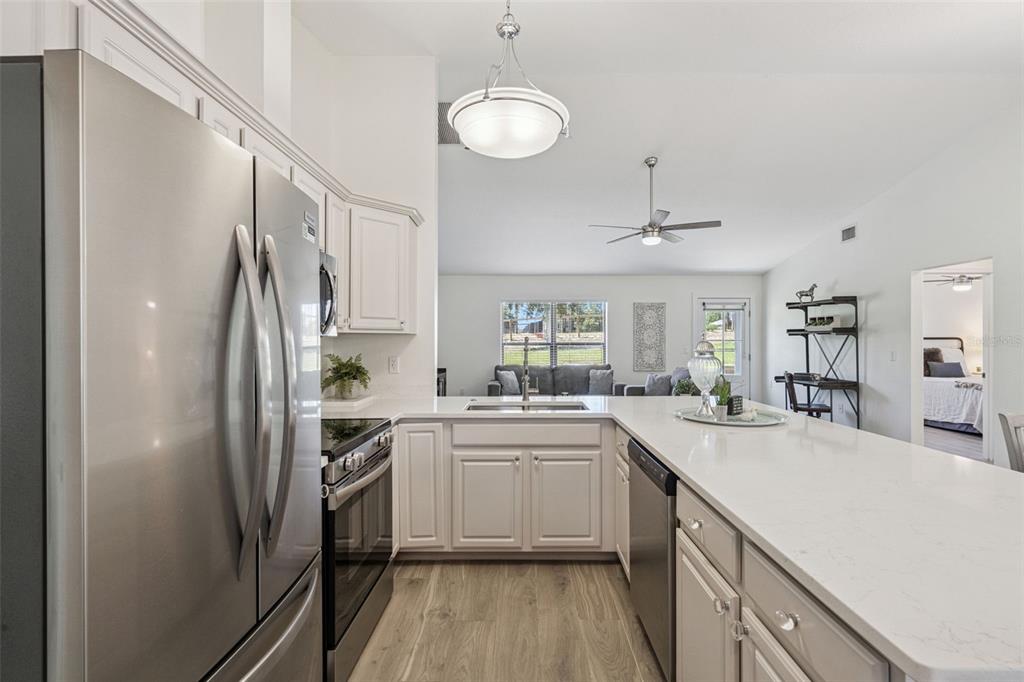 20701 County Road 44A Eustis, FL 32736 - Photo 57 of 73 a kitchen with white cabinets and stainless steel appliances
