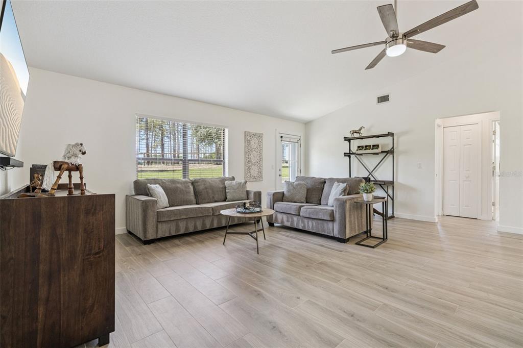 20701 County Road 44A Eustis, FL 32736 - Photo 60 of 73 a living room with furniture and a wooden floor