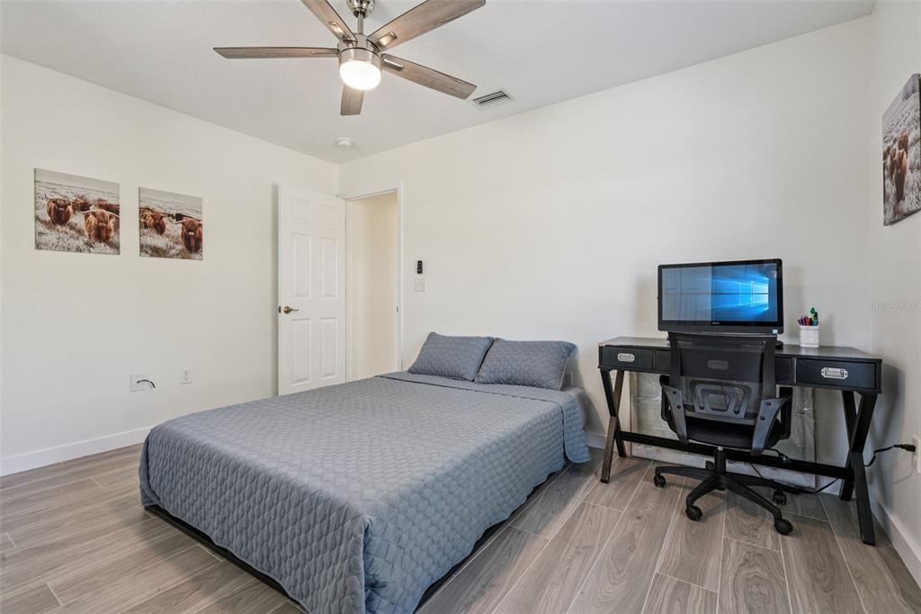 20701 County Road 44A Eustis, FL 32736 - Photo 69 of 73 a bedroom with a bed and a desk