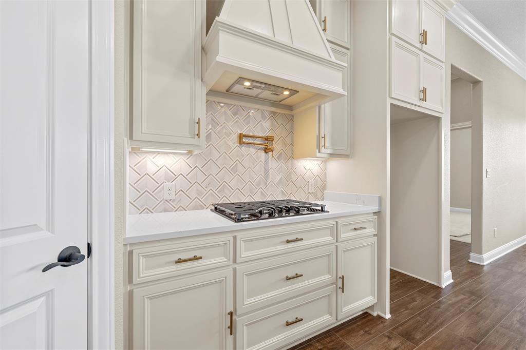 109 Water View Lane Robinson, TX 76706 - Photo 11 of 35 a kitchen with white cabinets and a stove with wooden floor