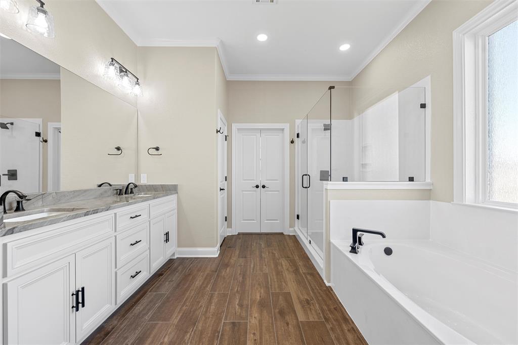 109 Water View Lane Robinson, TX 76706 - Photo 14 of 35 a spacious bathroom with a granite countertop sink a mirror a bathtub and shower