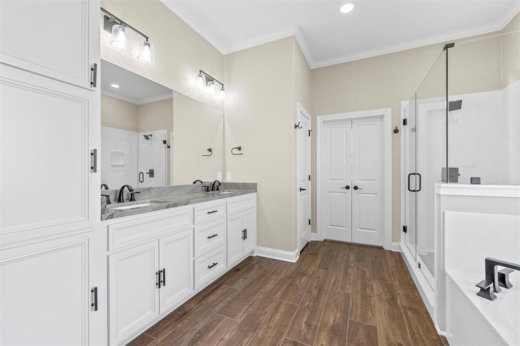 109 Water View Lane Robinson, TX 76706 - Photo 15 of 35 a bathroom with a sink a mirror a vanity and a shower
