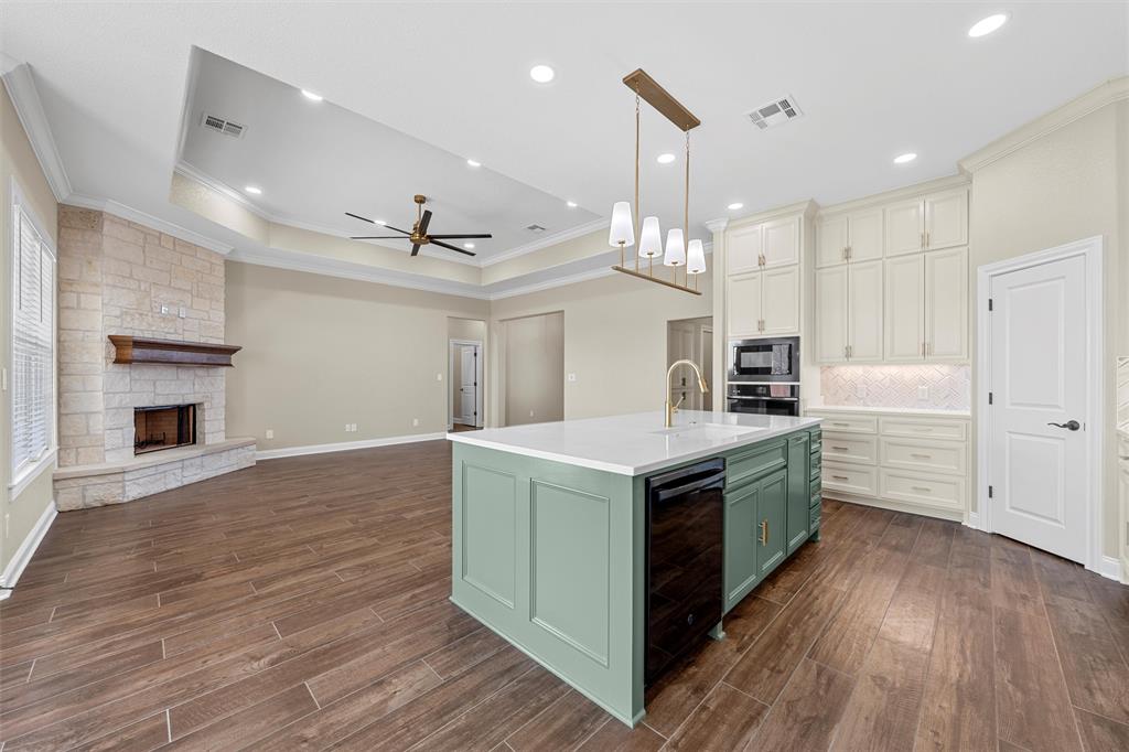 109 Water View Lane Robinson, TX 76706 - Photo 8 of 35 a kitchen with a stove and a wooden floor