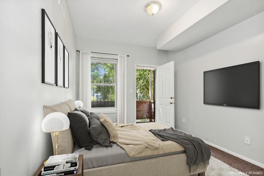 64 James Street, Unit 2 Newark, NJ 07102 - Photo 3 of 9 a bedroom with bed and a flat screen tv