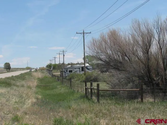 a view of a water pond with green yard