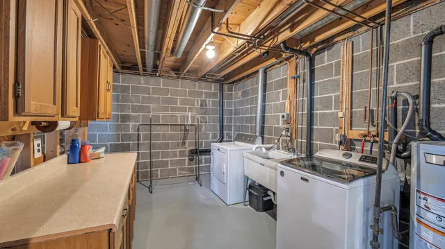 a bathroom with a granite countertop sink a toilet and shower