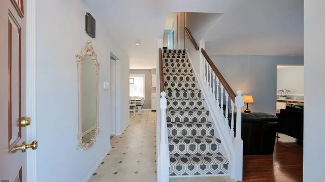 a view of a hallway with wooden floor and entryway