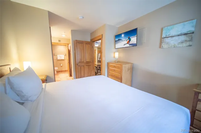 a bedroom with a bed and dresser