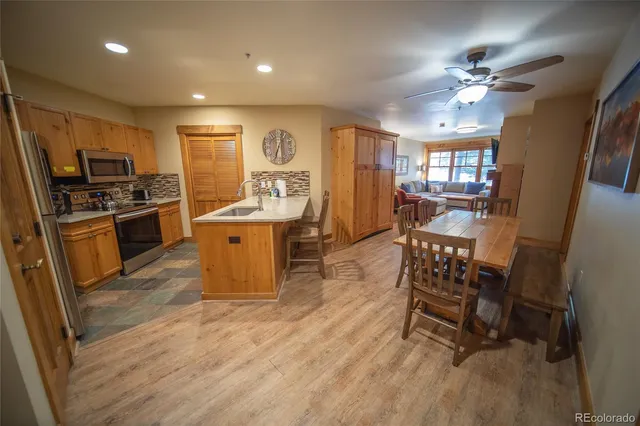 a very nice looking kitchen with a large counter top furniture appliances and cabinets