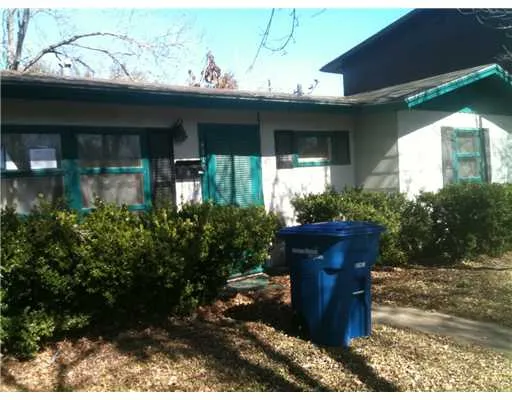 a view of a house with potted plants