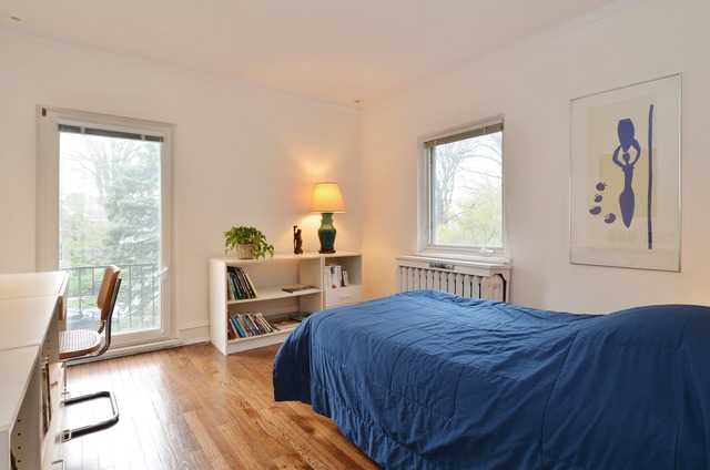 63 Abbotsford Road Winnetka, IL 60093 - Photo 19 of 25 a bedroom with a bed a table and chair with a large windows