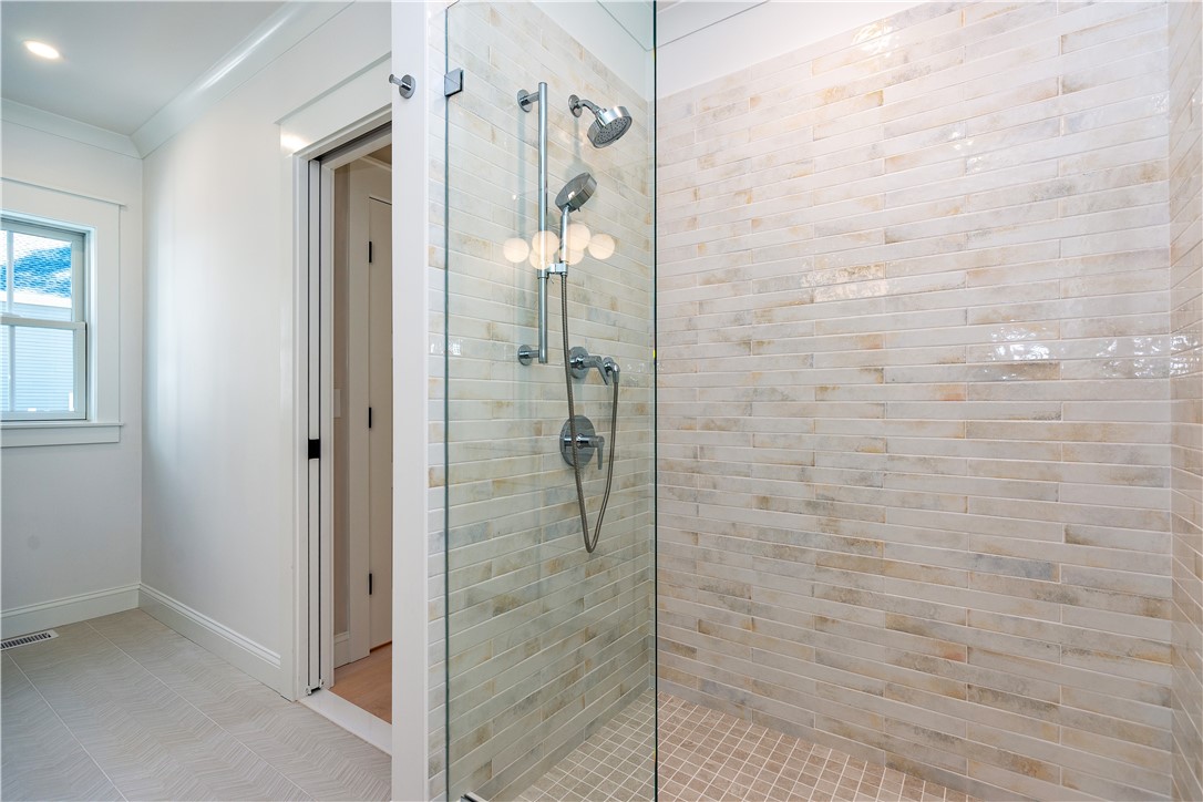 510 Greenbush Road Warwick, RI 02818 - Photo 28 of 49 Primary tiled shower with custom frameless door