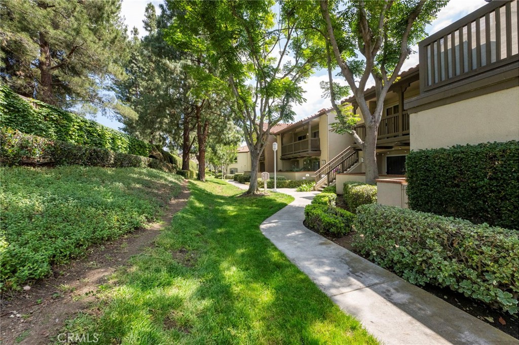 215 South Cross Creek Road, Unit L Orange, CA 92869 - Photo 1 of 50 a view of a yard with plants and large trees