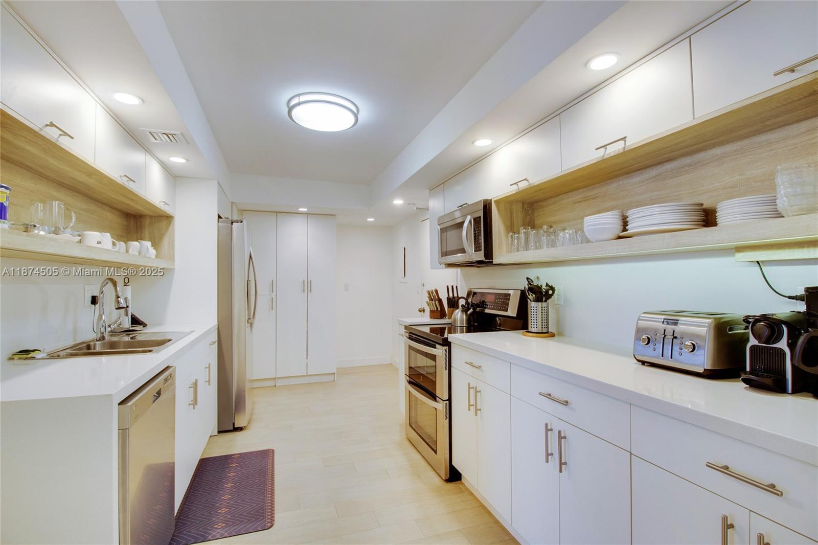 1111 Crandon Boulevard, Unit B606 Key Biscayne, FL 33149 - Photo 15 of 33 a kitchen with stainless steel appliances a sink stove and cabinets