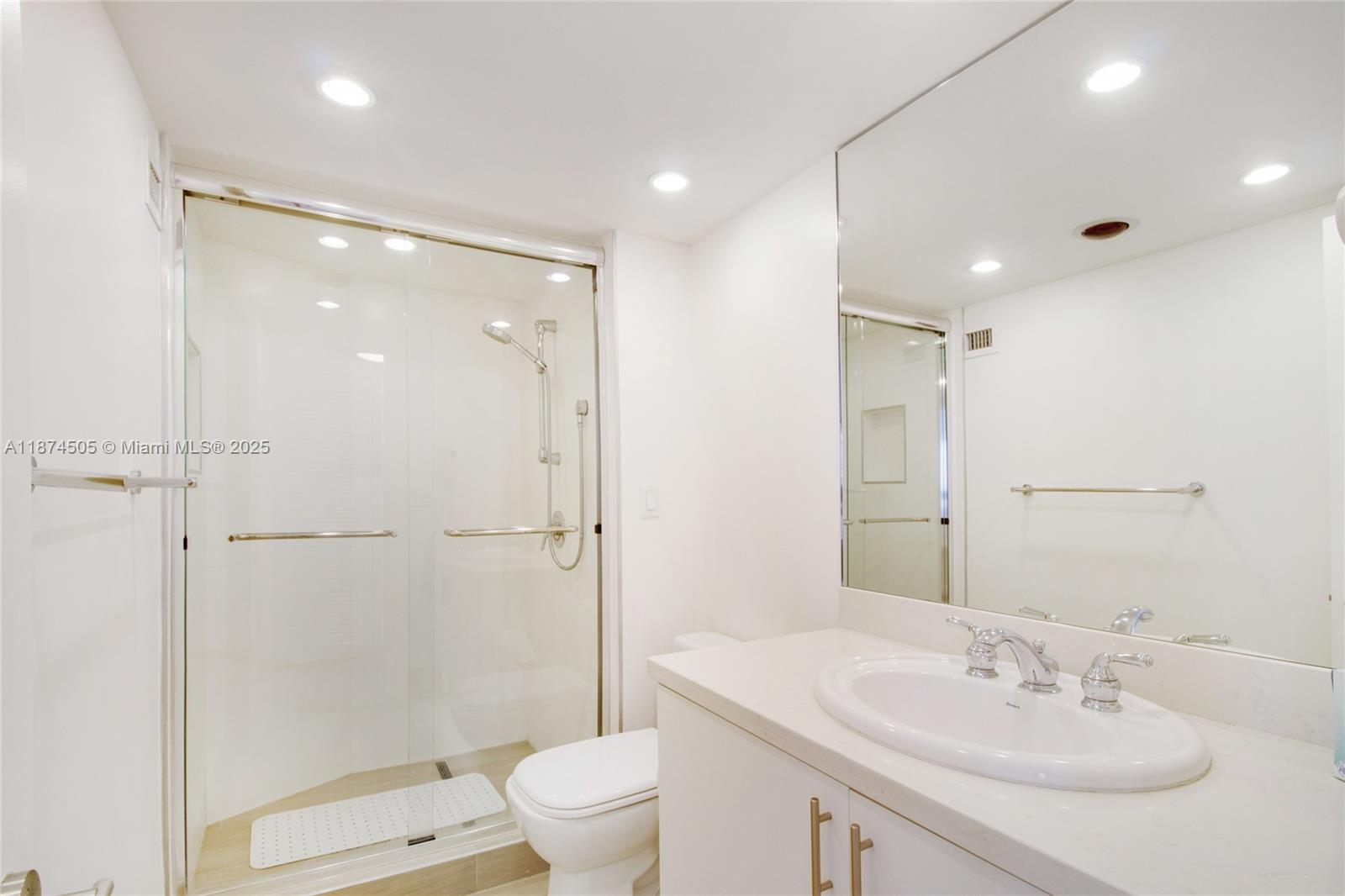 1111 Crandon Boulevard, Unit B606 Key Biscayne, FL 33149 - Photo 16 of 33 a bathroom with a sink toilet and shower