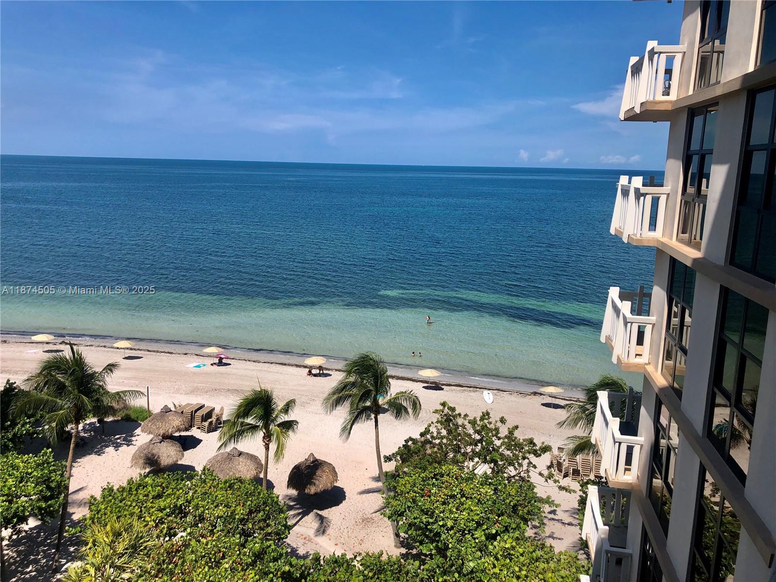 1111 Crandon Boulevard, Unit B606 Key Biscayne, FL 33149 - Photo 2 of 33 a view of a lake from a balcony