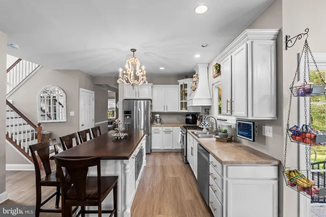 a kitchen with a table chairs stove and cabinets