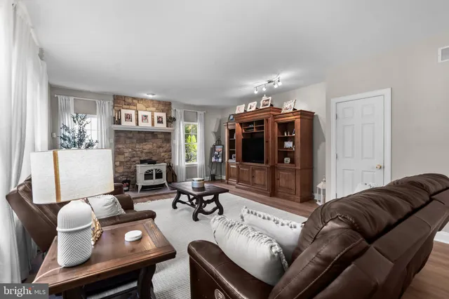 a living room with furniture fireplace and a flat screen tv