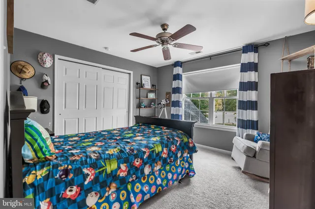 a bedroom with bed and a window