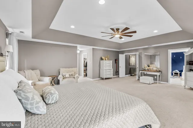 a bedroom with furniture and a chandelier