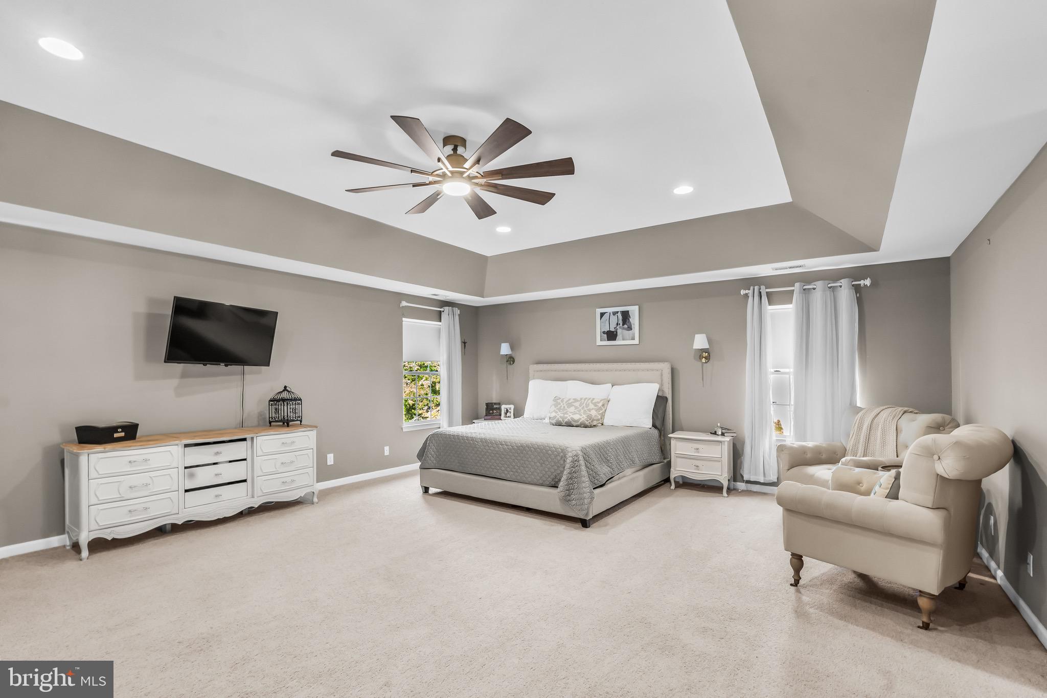 3653 Tuckahoe Road Franklinville, NJ 08322 - Photo 28 of 41 a spacious bedroom with a bed a couch and a flat screen tv