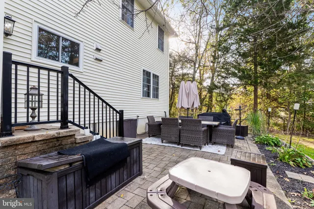 a view of a patio with table and chairs with wooden floor and fence