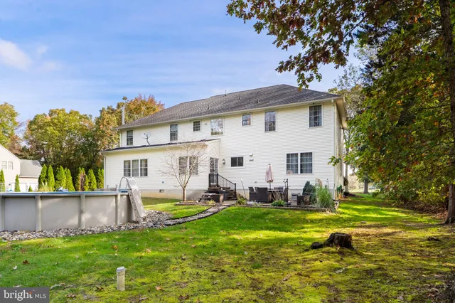 a view of a house with a big yard and potted plants