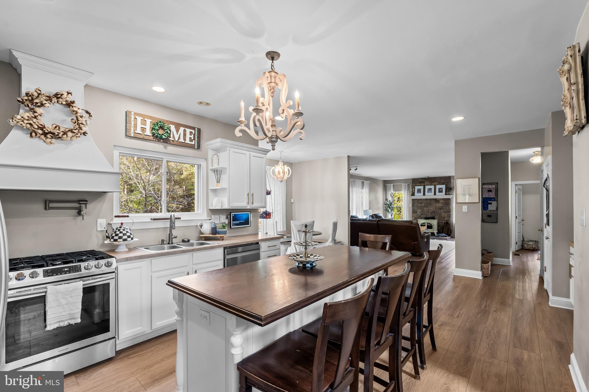 3653 Tuckahoe Road Franklinville, NJ 08322 - Photo 7 of 41 a kitchen with stainless steel appliances a dining table and chairs