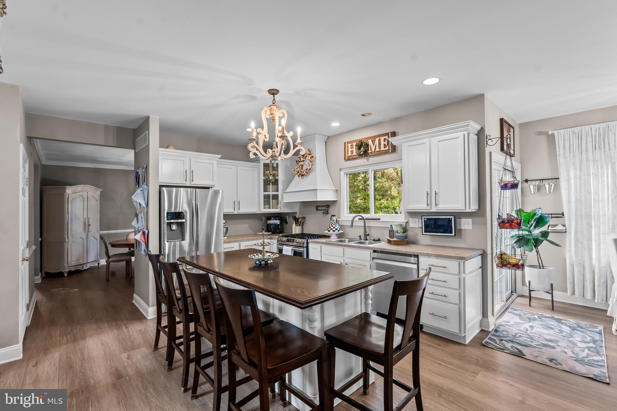 3653 Tuckahoe Road Franklinville, NJ 08322 - Photo 8 of 41 a kitchen with stainless steel appliances a dining table chairs and wooden floor
