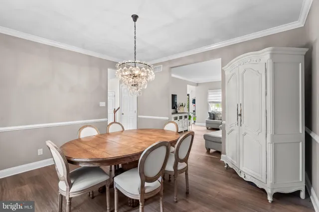 a view of a dining room with furniture wooden floor and chandelier