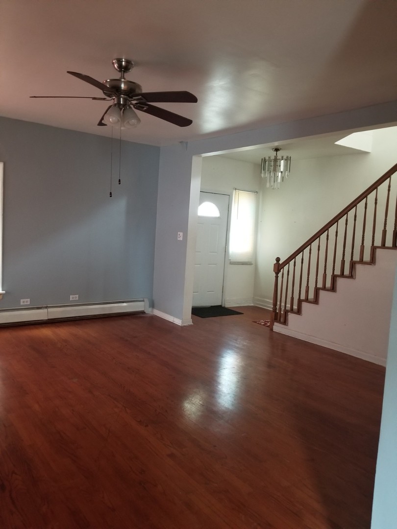 4019 North Tripp Avenue Chicago, IL 60641 - Photo 13 of 31 an empty room with wooden floor fan and windows