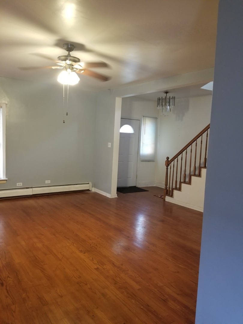 4019 North Tripp Avenue Chicago, IL 60641 - Photo 14 of 31 a view of a livingroom with a ceiling fan and hardwood floor