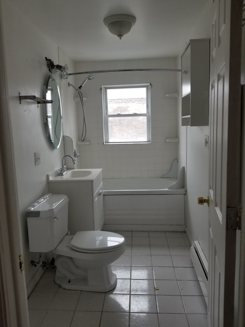 4019 North Tripp Avenue Chicago, IL 60641 - Photo 16 of 31 a bathroom with a toilet a sink and mirror