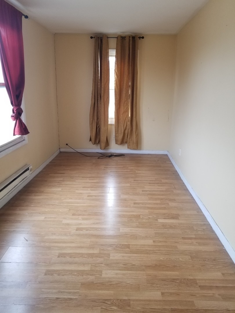 4019 North Tripp Avenue Chicago, IL 60641 - Photo 21 of 31 a view of an empty room with wooden floor and a window