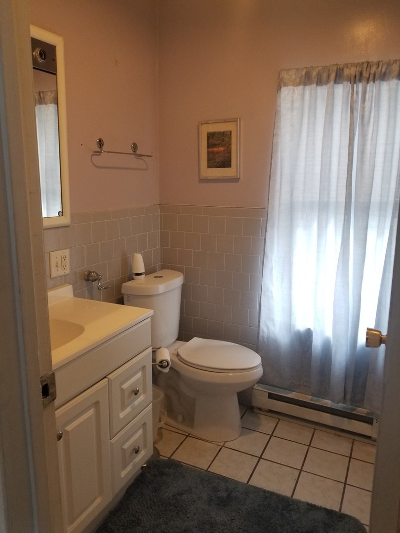 4019 North Tripp Avenue Chicago, IL 60641 - Photo 5 of 31 a white toilet sitting next to a bathroom sink