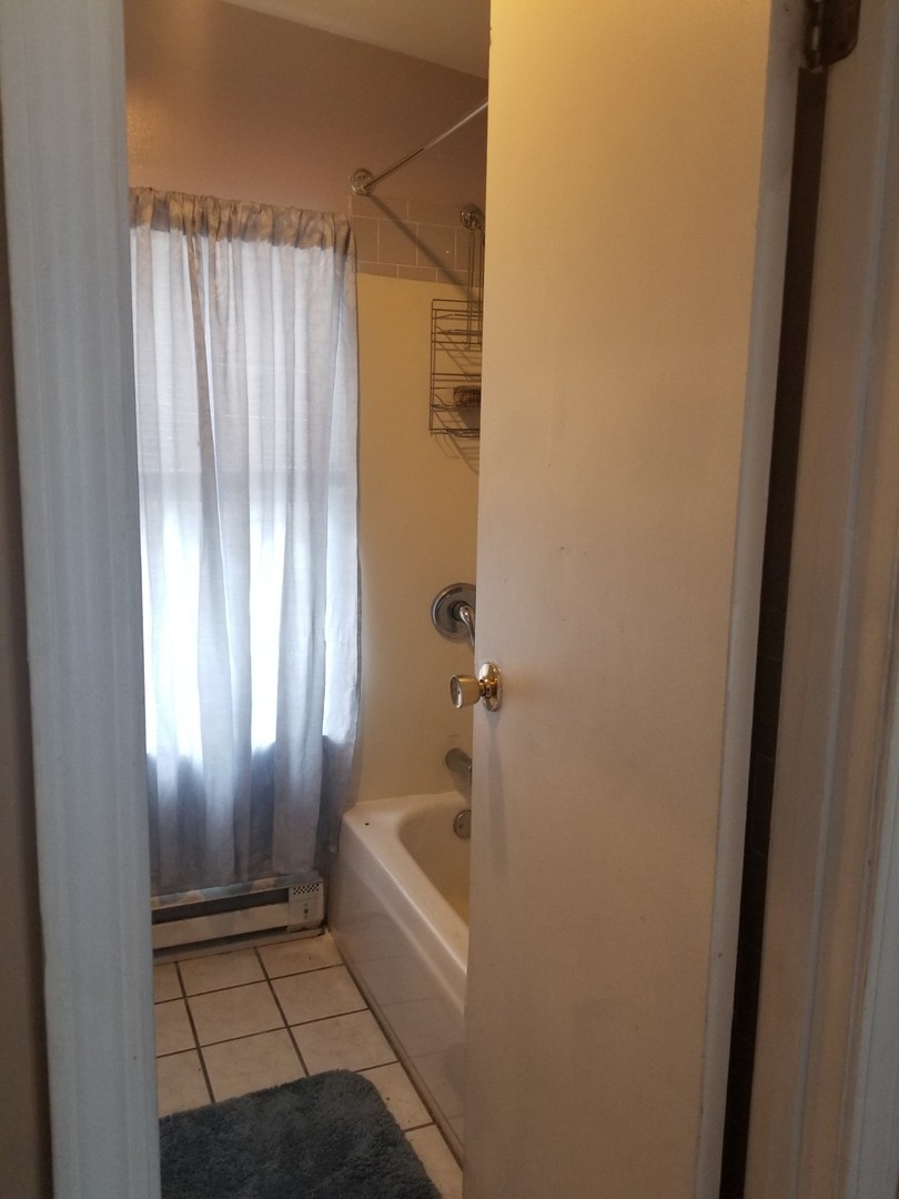 4019 North Tripp Avenue Chicago, IL 60641 - Photo 7 of 31 a bathroom with a bathtub and shower
