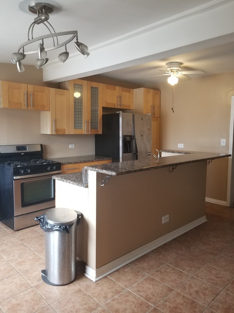 4019 North Tripp Avenue Chicago, IL 60641 - Photo 9 of 31 a kitchen with a stove and a microwave