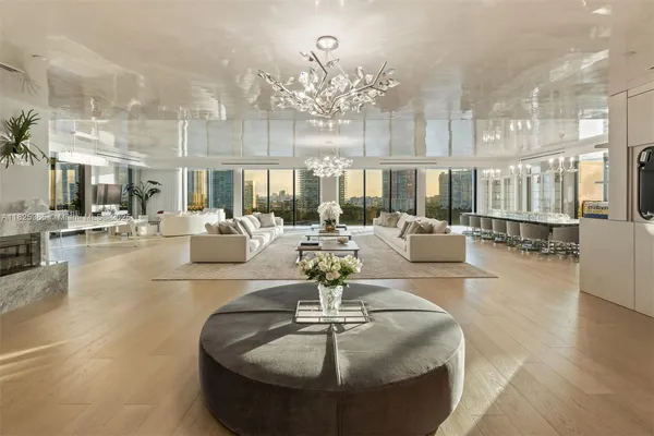 a living room with fireplace furniture and a chandelier