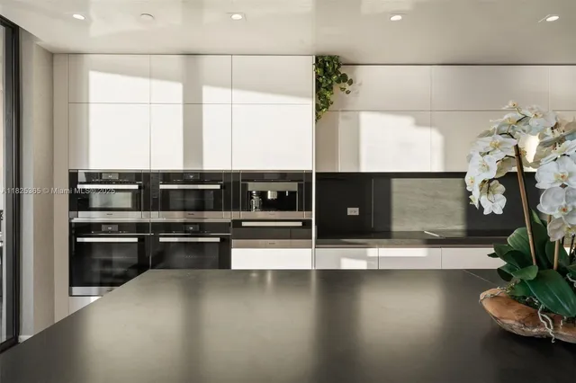 a view of a hallway with wooden floor and a flower pot