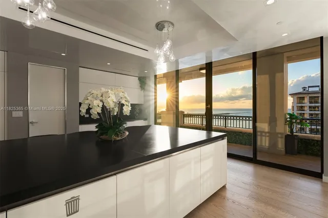 a bedroom with furniture and large windows